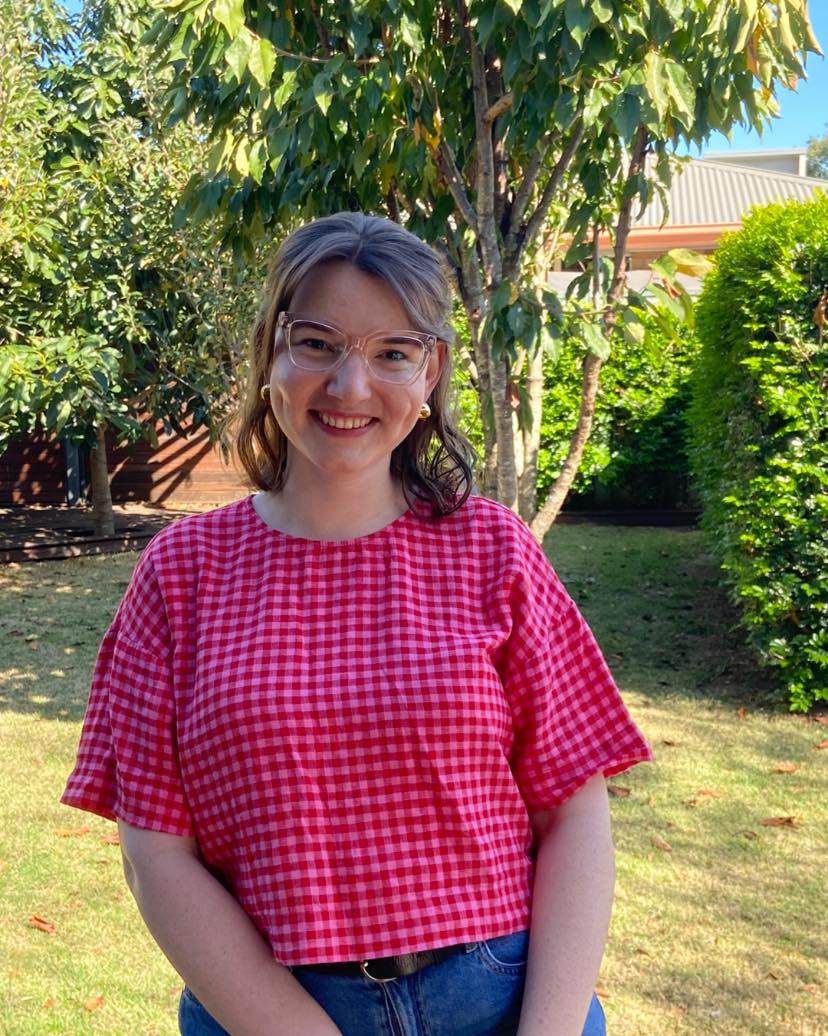 Toy library owner smiling with colourful toys